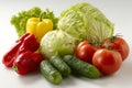 The image features green cabbage, yellow pepper, and red tomatoes and cucumbers set against a white background Royalty Free Stock Photo