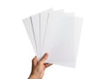 Hand holding four sheets of paper isolated on white background Royalty Free Stock Photo