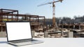Laptop on construction site, isolated on white background Royalty Free Stock Photo