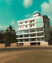 The image features a large building surrounded by trees under a clear blue sky.