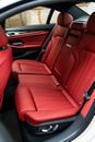 Luxurious red leather back passenger seats in stylish luxury car