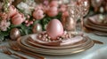 Pink Easter egg on a napkin with small flowers and gold-rimmed plates. Surrounded by pink tulips and glassware. Ideal Royalty Free Stock Photo