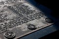 Image features a metal plaque with various military words inscribed on it