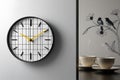 The image features a meticulously crafted wall clock, set against a pristine white backdrop. Royalty Free Stock Photo