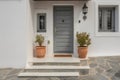 Contemporary Residential Entrance with Gray Front Door and Decorative Windows Royalty Free Stock Photo