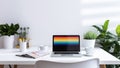 A modern home office setup with laptop and a rainbow flag on screen, for pride day. Generative AI. Royalty Free Stock Photo