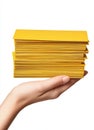 An image features a person holding a stack of yellow envelopes, and there is also a person holding a stack of yellow Royalty Free Stock Photo