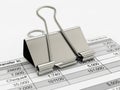 Silver binder clip on financial document isolated on white background Royalty Free Stock Photo