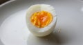 Perfectly Cut Hard Boiled Egg Half on a White Plate Royalty Free Stock Photo