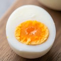 Hard-boiled egg halved on wooden surface Royalty Free Stock Photo