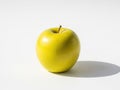 Single vibrant green apple casts a soft shadow Royalty Free Stock Photo