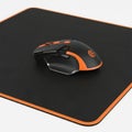 Wireless gaming mouse on mousepad isolated on white background Royalty Free Stock Photo