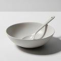 Image features a smooth, white ceramic bowl with a matching spoon Royalty Free Stock Photo