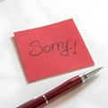 Red Sticky Note with Sorry Message and Pen Royalty Free Stock Photo