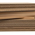 Stack of corrugated cardboard sheets isolated on white background Royalty Free Stock Photo