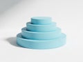 A stack of four pastel blue circular objects in descending size order against a light gray background. isolated on white Royalty Free Stock Photo