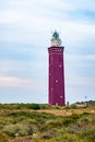Majestic Red Lighthouse Standing Guard Over Coastal Dunes