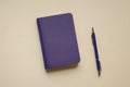 Purple Notebook and Pen Against a Light Background