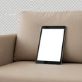 Tablet on couch isolated on white background isolated on white background Royalty Free Stock Photo