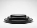 Three black circular objects stacked, isolated on white background Royalty Free Stock Photo