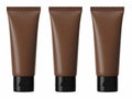 Three tubes of dark brown cosmetic product against white background Royalty Free Stock Photo