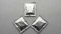 Three shiny aluminum foil packages Royalty Free Stock Photo