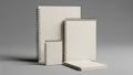 Three spiral-bound notebooks in white against gray background Royalty Free Stock Photo