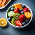 A top-down view of a colorful fruit salad with strawberries, kiwis, blueberries, and bananas