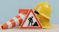 Construction Warning Sign with Traffic Cone and Hard Hat safety Royalty Free Stock Photo