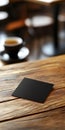 Black Square Card on Wooden Surface Royalty Free Stock Photo