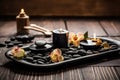 Hot Stone Massage Spa Treatment with Aromatherapy Candles and Dry Flowers Royalty Free Stock Photo