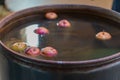 An image featuring a rustic, vintage scene of a copper pot filled with soaking cherries on a concretestone countertop Royalty Free Stock Photo