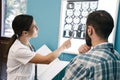 Image of female doctor and patient man looking at x-ray scan in hospital Royalty Free Stock Photo