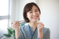 Female employee with 500 yen coin and chopsticks Royalty Free Stock Photo
