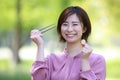 Female employee with 500 yen coin and chopsticks Royalty Free Stock Photo