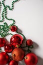 a red ball christmas tree with green ornaments and beads on the table Royalty Free Stock Photo