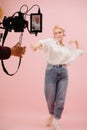 Image in field monitor of a young woman dance-walking towards the camera