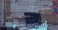 Image of financial data processing and binary coding over laptop on desk Royalty Free Stock Photo