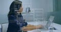 Image of financial data processing over biracial businesswoman using laptop in office