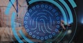 Image of fingerprint in circles over hands of caucasian man typing on laptop