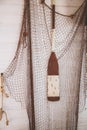 Fishing net and a paddle for a canoe hanging on the wall Royalty Free Stock Photo