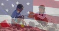 Image of flag of united states of america over biracial boy and girl playing with sand on beach Royalty Free Stock Photo