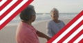 Image of flag of united states of america over senior biracial couple dancing on beach Royalty Free Stock Photo