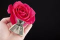 Image of flower money hand dark background