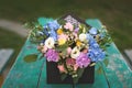 Image of lovely flowers arrangement with blue hydrangea, white eustoma, spray roses, carnations on the wooden table Royalty Free Stock Photo