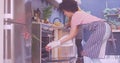 Image of flowers over happy diverse couple cooking together Royalty Free Stock Photo