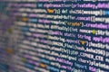 Image of a focused computer screen displaying colorful lines of code, potentially JavaScript or Python Emphasis on