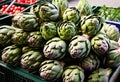 An image of fresh artichokes on a market stall. Royalty Free Stock Photo
