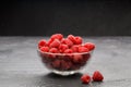 Image of fresh raspberries in transparent glass cup Royalty Free Stock Photo