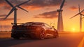 The image in front of the sports car scene behind as the sun going down with wind turbines in the back. Royalty Free Stock Photo